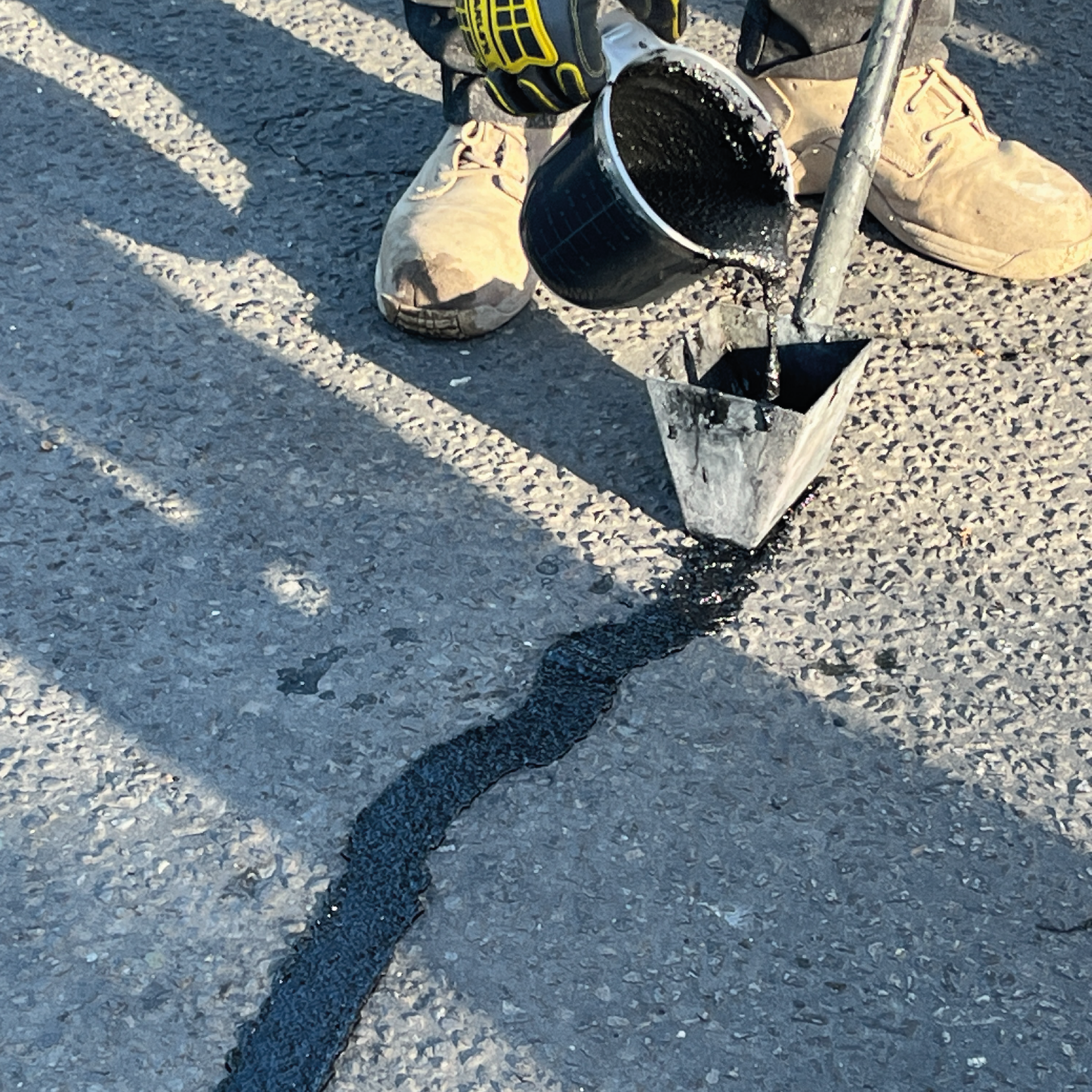 UltraCrack L270 being applied on asphalt crack